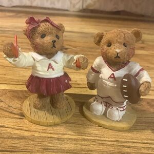Crimson Tide cheerleader and football player collectable figurines.